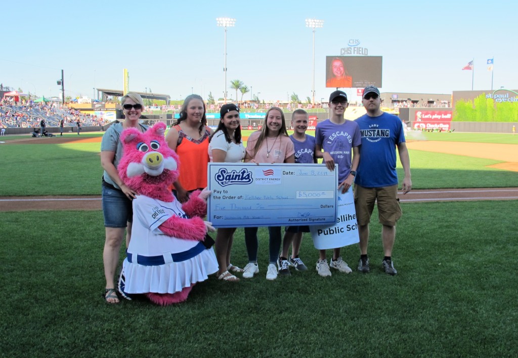 Kelliher Public School students stand with giant check at CHS Field